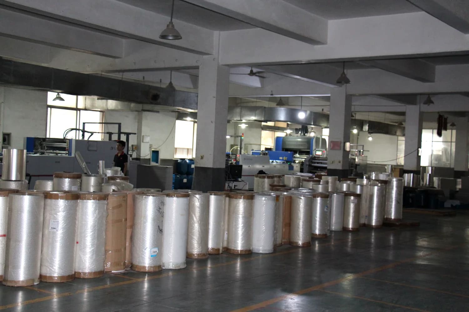 Partner production workshop with rolls prepared for food wrapping paper conversion